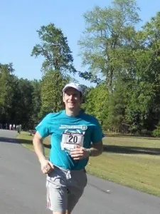 Denis O'Hare running down a street.
