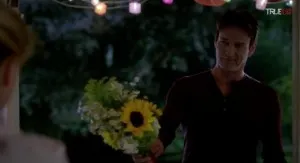 Bill Compton (Stephen Moyer) offers Sookie Stackhouse (Anna Paquin) some flowers in HBO's True Blood Season 7 Episode 5 (entitled 'Lost Cause')